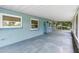 Spacious covered porch with blue block construction and screened-in lanai at 507 Sand Ave, Apopka, FL 32703