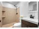 Bathroom featuring a spacious shower with brown tile, new fixtures, and updated vanity at 510 Apollo Ave, Deltona, FL 32725