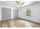 Bedroom with wood-look floors, closet, and window view of the pool area at 510 Apollo Ave, Deltona, FL 32725