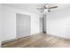 Bedroom featuring a ceiling fan, closet, neutral paint, and wood-look flooring at 510 Apollo Ave, Deltona, FL 32725