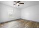 Bedroom featuring a ceiling fan, wood-look flooring, and a window view at 510 Apollo Ave, Deltona, FL 32725