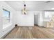 Bright dining area features wood floors, a modern light fixture, and neutral decor at 510 Apollo Ave, Deltona, FL 32725
