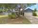 Charming single-Gathering home featuring a lush front yard with mature trees and a welcoming two-car garage at 510 Apollo Ave, Deltona, FL 32725