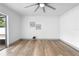 Bright living area featuring stylish floors, a modern ceiling fan, and sliding glass doors with abundant natural light at 510 Apollo Ave, Deltona, FL 32725