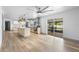 Bright, spacious living area with a modern kitchen, stylish flooring, and sliding glass doors that lead to the outdoors at 510 Apollo Ave, Deltona, FL 32725