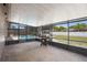 A covered patio includes a BBQ grill, and a view of the pool and backyard at 510 Apollo Ave, Deltona, FL 32725