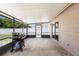 A view of a covered patio with a BBQ grill, and a view of the backyard at 510 Apollo Ave, Deltona, FL 32725
