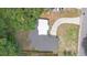 Aerial view showcases the house's dark roof, winding driveway, and green surroundings at 5204 Van Aken Dr, Orlando, FL 32808