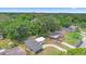 An aerial view of a single Gathering home with mature trees, fenced yard and long, curved driveway at 5204 Van Aken Dr, Orlando, FL 32808