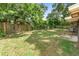 Private backyard enclosed by a wooden fence, featuring a concrete patio area and plenty of green space at 5204 Van Aken Dr, Orlando, FL 32808