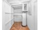 Finished basement with water heater, white painted walls, and tile floor at 5204 Van Aken Dr, Orlando, FL 32808