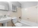 Well-lit bathroom featuring a standard shower-tub, toilet, sink, and mirror at 5204 Van Aken Dr, Orlando, FL 32808
