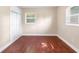 Inviting bedroom with hardwood floors, large closets, and multiple windows for natural light at 5204 Van Aken Dr, Orlando, FL 32808