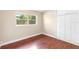 A cozy bedroom features hardwood floors, ample natural light, and closet for storage at 5204 Van Aken Dr, Orlando, FL 32808