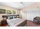 Cozy bedroom with a comfortable bed, nightstands, a ceiling fan and ample natural light at 5204 Van Aken Dr, Orlando, FL 32808