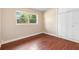 A cozy bedroom features hardwood floors, ample natural light, and closet for storage at 5204 Van Aken Dr, Orlando, FL 32808