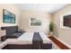 Comfortable bedroom featuring a large window, a TV, and stylish décor with plant accents at 5204 Van Aken Dr, Orlando, FL 32808