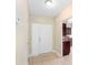 A well-lit entryway with tile flooring and a solid white front door leading to the main living areas at 5204 Van Aken Dr, Orlando, FL 32808