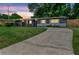 Charming one-story home with a long driveway and inviting curb appeal at dusk at 5204 Van Aken Dr, Orlando, FL 32808