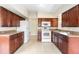 Well-maintained kitchen with dark wood cabinets, ample counter space, and modern appliances at 5204 Van Aken Dr, Orlando, FL 32808