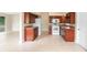 Spacious kitchen with warm-toned cabinets, white appliances, and plenty of natural light at 5204 Van Aken Dr, Orlando, FL 32808
