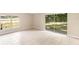 Bright living room with tile floors, a large window, and sliding glass doors to the backyard at 5204 Van Aken Dr, Orlando, FL 32808