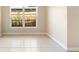 Neutral living space with tile flooring, large window letting in natural light, and neutral color scheme at 5204 Van Aken Dr, Orlando, FL 32808