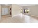 Spacious living area with neutral tile flooring, front door, and windows for natural light at 5204 Van Aken Dr, Orlando, FL 32808