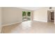 Inviting living space with tile flooring, neutral colors, and sliding glass doors to the backyard at 5204 Van Aken Dr, Orlando, FL 32808