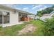 Backyard view featuring a covered patio and two-person hot tub at 5445 Turton Ln, Port Orange, FL 32127