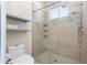 Bathroom includes a glass shower, tile surround, and floating shelves at 5445 Turton Ln, Port Orange, FL 32127