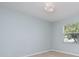 A bright bedroom with wood-look floors and a window at 5445 Turton Ln, Port Orange, FL 32127