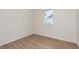 This bedroom features a window with blinds and laminate flooring at 5445 Turton Ln, Port Orange, FL 32127