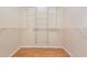 A walk-in closet with adjustable wire shelving and wood-look floor at 5445 Turton Ln, Port Orange, FL 32127