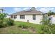 Exterior view of home with solar panels, sunroom, and shed at 5445 Turton Ln, Port Orange, FL 32127