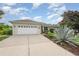 Charming single-story home boasts a two-car garage and well-manicured lawn with desert-style landscaping at 5445 Turton Ln, Port Orange, FL 32127