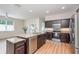 A kitchen showcasing an island, stainless steel appliances, granite counters and dark wood cabinetry at 5445 Turton Ln, Port Orange, FL 32127