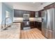 This kitchen features stainless steel appliances, granite countertops, and wood flooring at 5445 Turton Ln, Port Orange, FL 32127