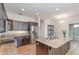 This kitchen offers an island with a sink, stainless steel appliances and granite countertops at 5445 Turton Ln, Port Orange, FL 32127