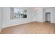 Bright living room featuring new wood floors, a large window, and a front door at 5445 Turton Ln, Port Orange, FL 32127