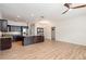 Open floor plan with wood floors leads to kitchen with dark cabinets and island at 5445 Turton Ln, Port Orange, FL 32127