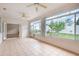 Bright sunroom with tiled flooring and many windows overlooking a fenced-in yard at 5445 Turton Ln, Port Orange, FL 32127