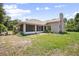 The home features a screened-in porch and a spacious backyard at 570 Cypress Ave, Orange City, FL 32763