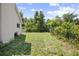The backyard features a chain-link fence and mature landscaping at 570 Cypress Ave, Orange City, FL 32763
