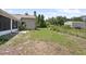 The spacious backyard features a screened-in porch and mature landscaping at 570 Cypress Ave, Orange City, FL 32763