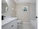 Bathroom features a single sink vanity and shower/tub combo with tile surround at 570 Cypress Ave, Orange City, FL 32763