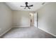 Neutral bedroom features neutral walls and carpet and a ceiling fan at 570 Cypress Ave, Orange City, FL 32763
