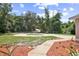 Lush front yard featuring a circular driveway, a walkway, and mature landscaping at 570 Cypress Ave, Orange City, FL 32763