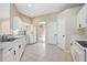 Bright kitchen with white cabinets, tile flooring and stainless steel sink at 570 Cypress Ave, Orange City, FL 32763
