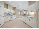 Bright open kitchen with white cabinets and appliances overlooks the living room at 570 Cypress Ave, Orange City, FL 32763